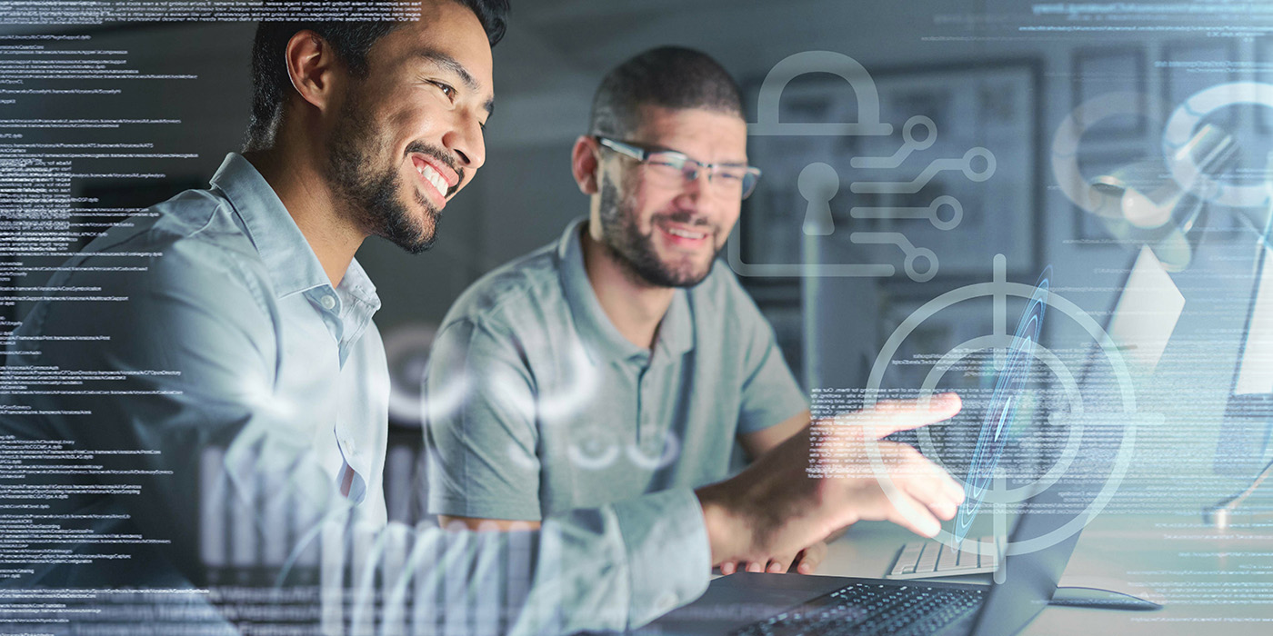Images/Continuing Ed/Information tech/2409prod-LBC117-CompTIA-PenTest-Plus-Training-Boot-Camp-1400x700.jpg two men point at a laptop screen while smiling