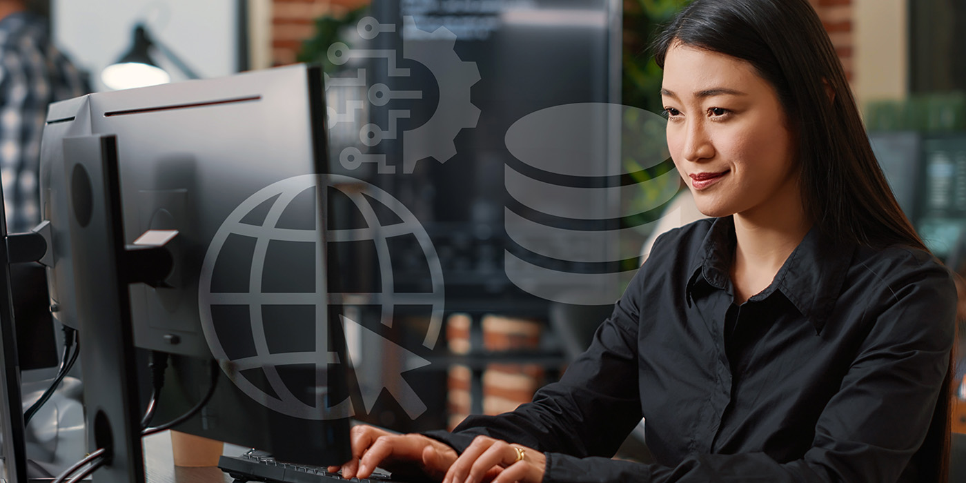 asian female coding at a computer 